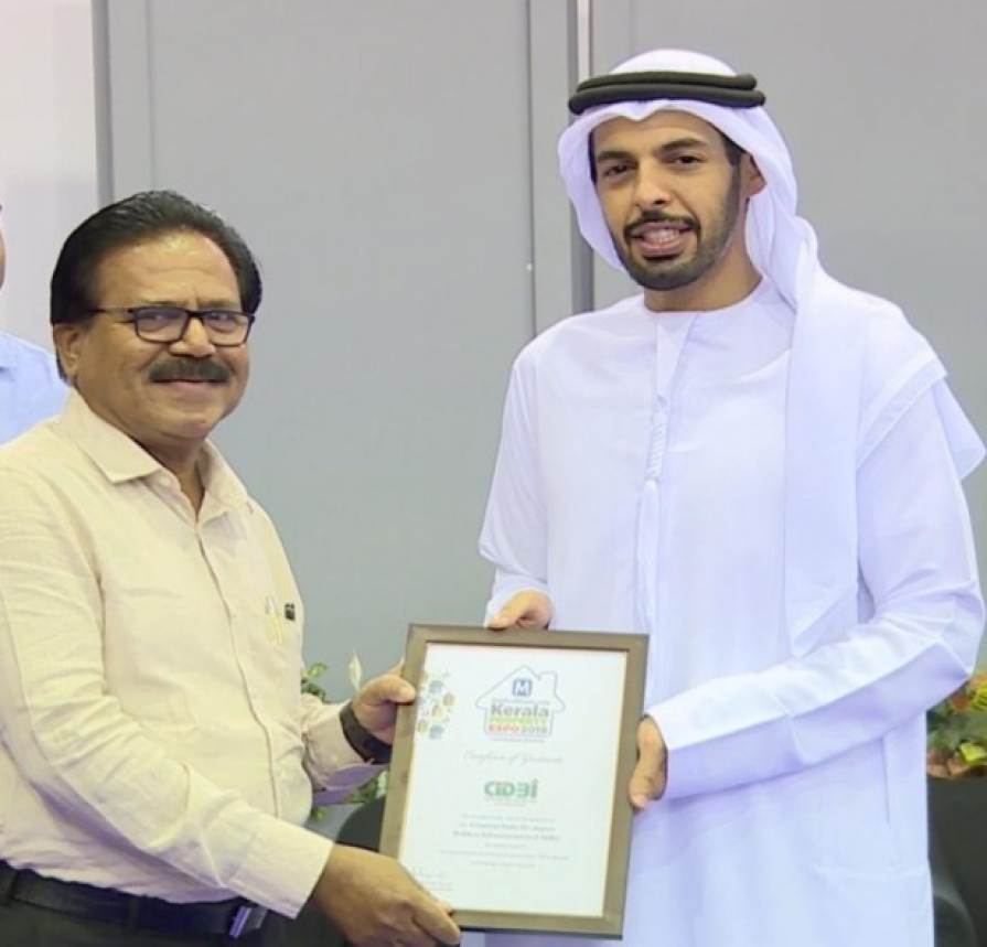 Receiving certificate of gratitude award from Sharjaah Sheikh